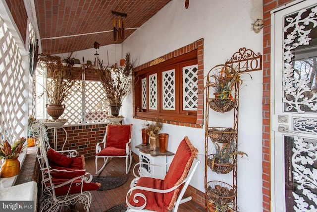 sitting room featuring brick floor and brick ceiling