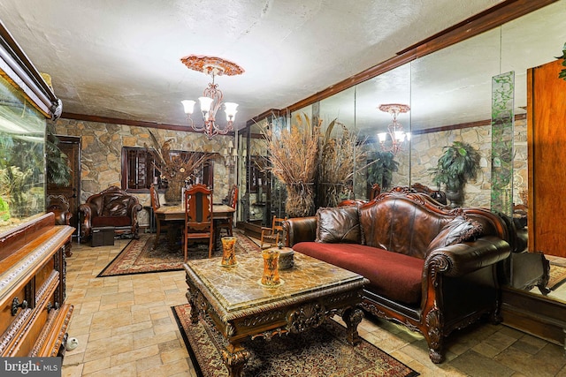 living room featuring a textured ceiling, ornamental molding, stone tile flooring, and a notable chandelier