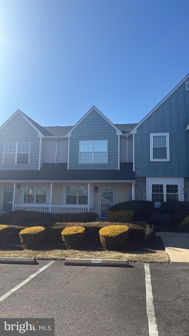 townhome / multi-family property with uncovered parking and board and batten siding