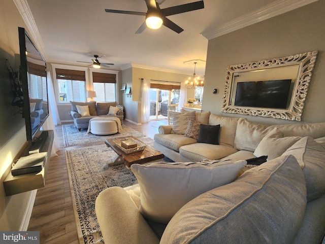 living room with ornamental molding, plenty of natural light, baseboards, and wood finished floors