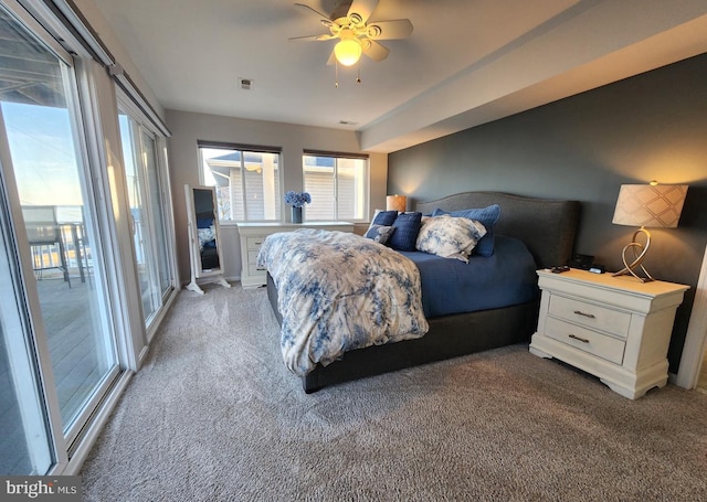 bedroom featuring light carpet, a ceiling fan, visible vents, and access to exterior