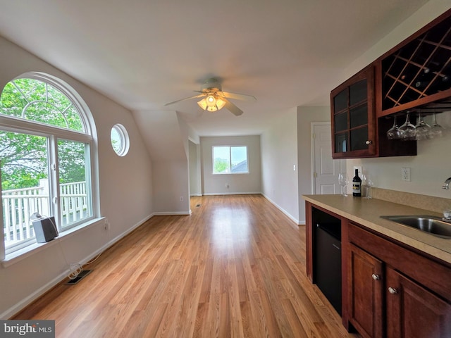 5128 Shore Dr, Huntingtown, MD 20639 - kitchen featuring a sink, light wood-style flooring, light countertops, glass insert cabinets, and ceiling fan