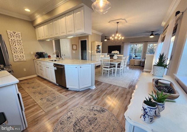 kitchen with dishwasher, ornamental molding, open floor plan, a peninsula, and a sink