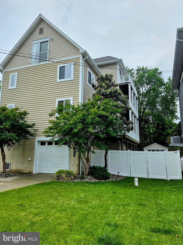 5128 Shore Dr, Huntingtown, MD 20639 - view of side of property featuring an attached garage and driveway