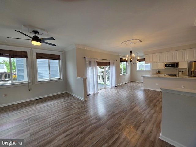5128 Shore Dr, Huntingtown, MD 20639 - kitchen with stainless steel appliances, open floor plan, a chandelier, white cabinetry, and dark wood finished floors