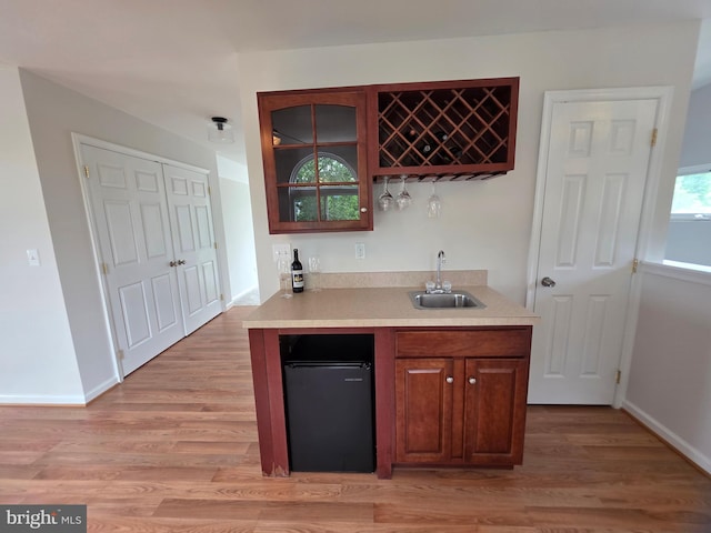 5128 Shore Dr, Huntingtown, MD 20639 - kitchen with a sink, light countertops, glass insert cabinets, light wood finished floors, and refrigerator