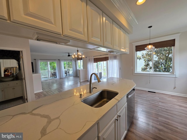 5128 Shore Dr, Huntingtown, MD 20639 - kitchen with a sink, stainless steel dishwasher, wood finished floors, decorative light fixtures, and ornamental molding