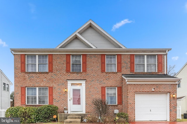 view of front of property featuring a garage and brick siding