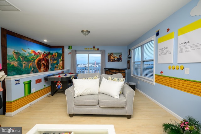 interior space with wood finished floors, visible vents, and baseboards