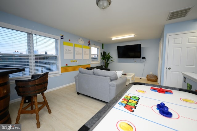 rec room featuring baseboards, visible vents, and light wood-style floors