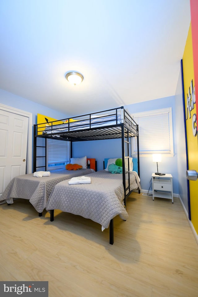 bedroom featuring baseboards and wood finished floors