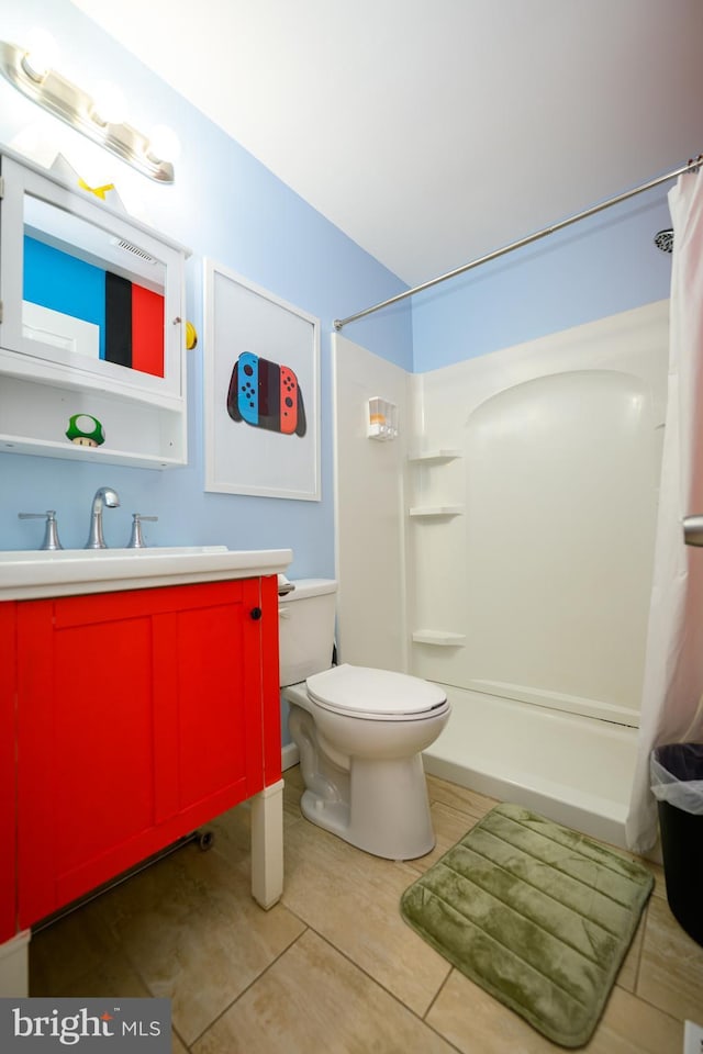 full bath featuring curtained shower, vanity, toilet, and tile patterned floors