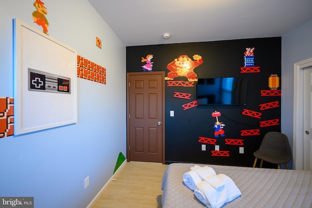 bedroom featuring baseboards and wood finished floors