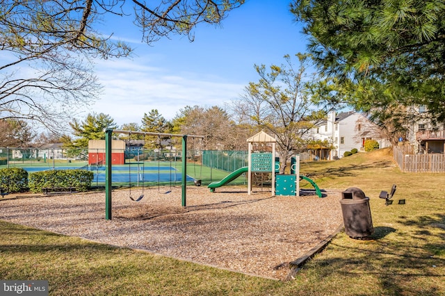 communal playground with a lawn and fence