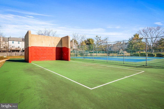 view of sport court featuring fence