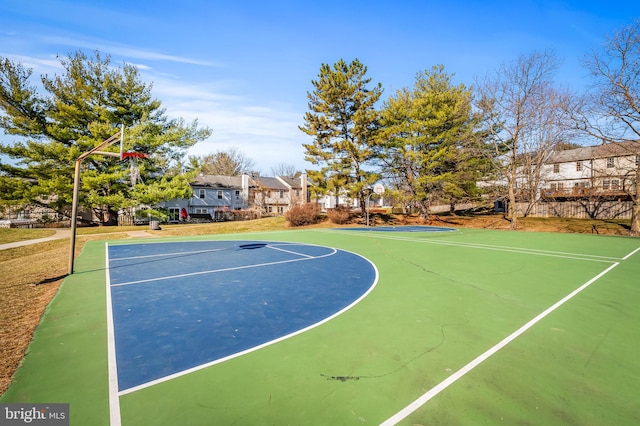 view of basketball court featuring a residential view and community basketball court