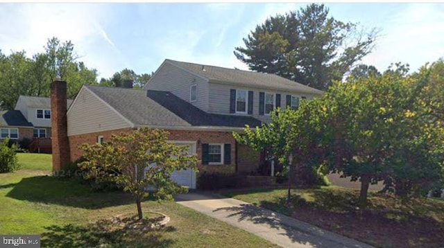 view of front of house featuring a garage, brick siding, concrete driveway, and a front yard