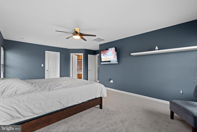 carpeted bedroom with baseboards, a ceiling fan, visible vents, and ensuite bath
