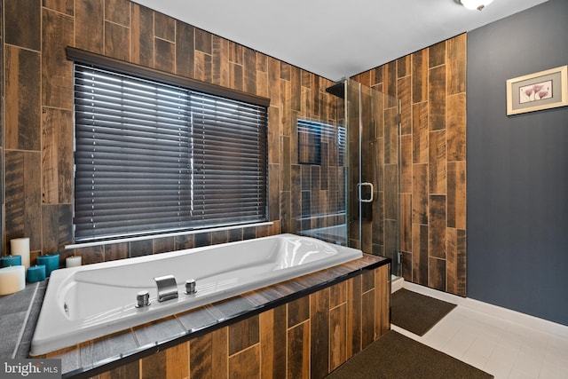 full bathroom featuring a bath and a stall shower