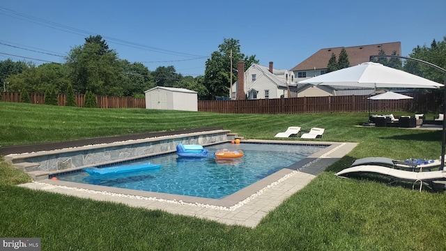 view of swimming pool with a fenced in pool, a fenced backyard, a yard, a storage unit, and an outdoor structure