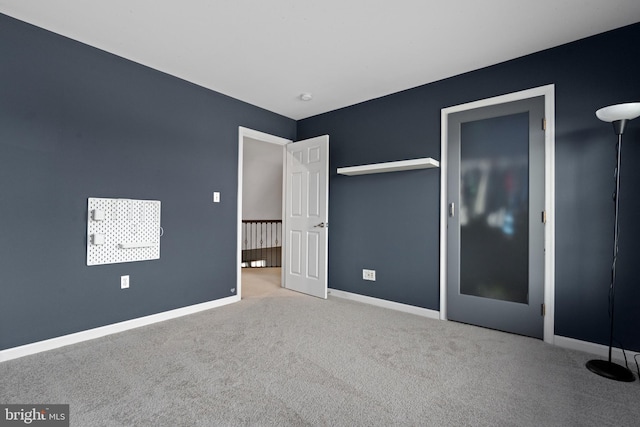 unfurnished bedroom featuring baseboards and carpet