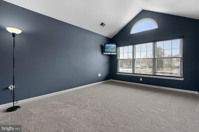 unfurnished room featuring visible vents, baseboards, carpet, and vaulted ceiling
