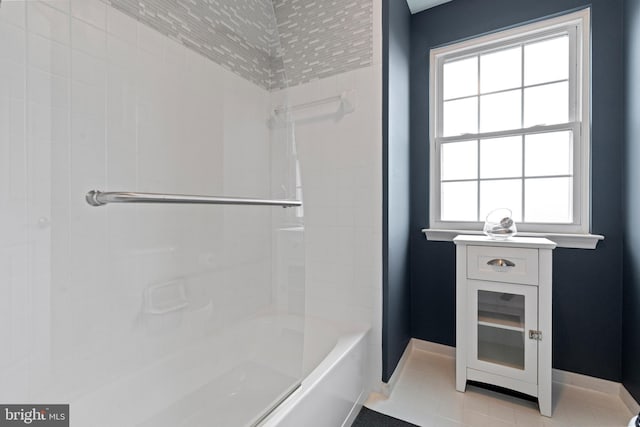 full bathroom with a wealth of natural light, shower / tub combination, and baseboards