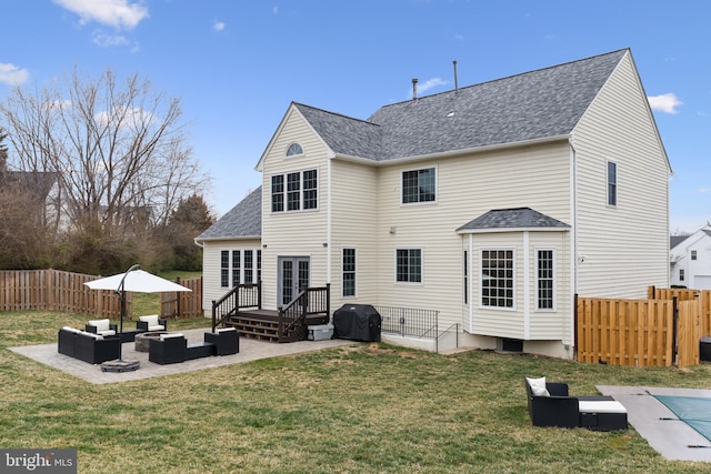 back of property featuring a shingled roof, a patio area, a yard, outdoor lounge area, and a fenced backyard