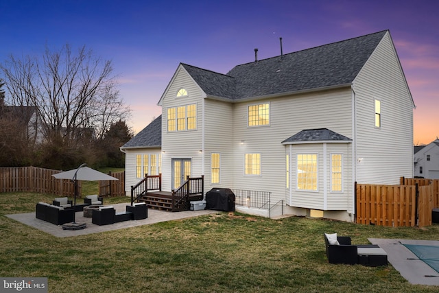 rear view of house featuring an outdoor hangout area, a yard, fence private yard, a patio, and french doors