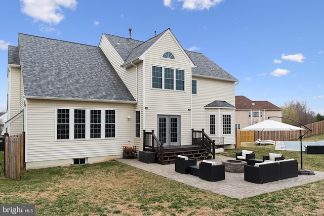 back of house featuring an outdoor living space with a fire pit, a yard, a patio area, and fence