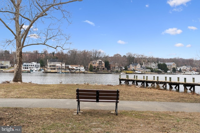 view of dock featuring a water view and a residential view