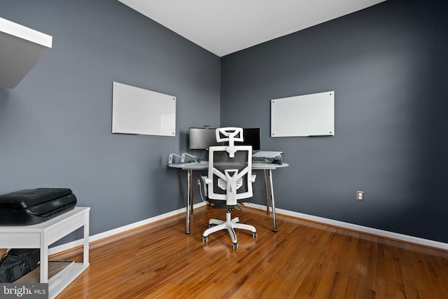 office area with wood finished floors and baseboards