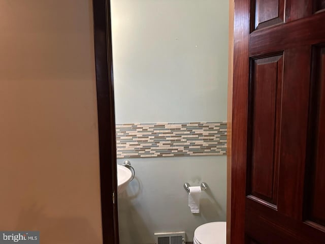 bathroom featuring toilet and visible vents