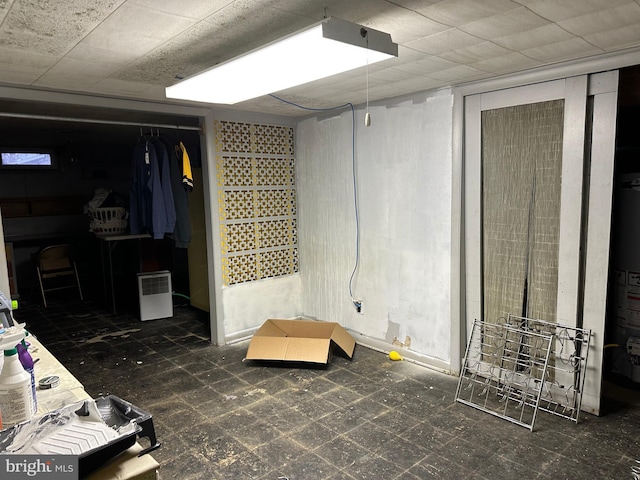 basement featuring gas water heater and tile patterned floors