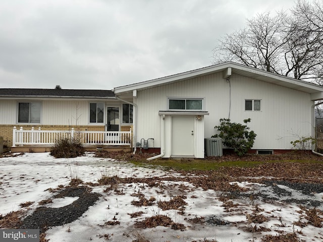 exterior space with cooling unit and brick siding