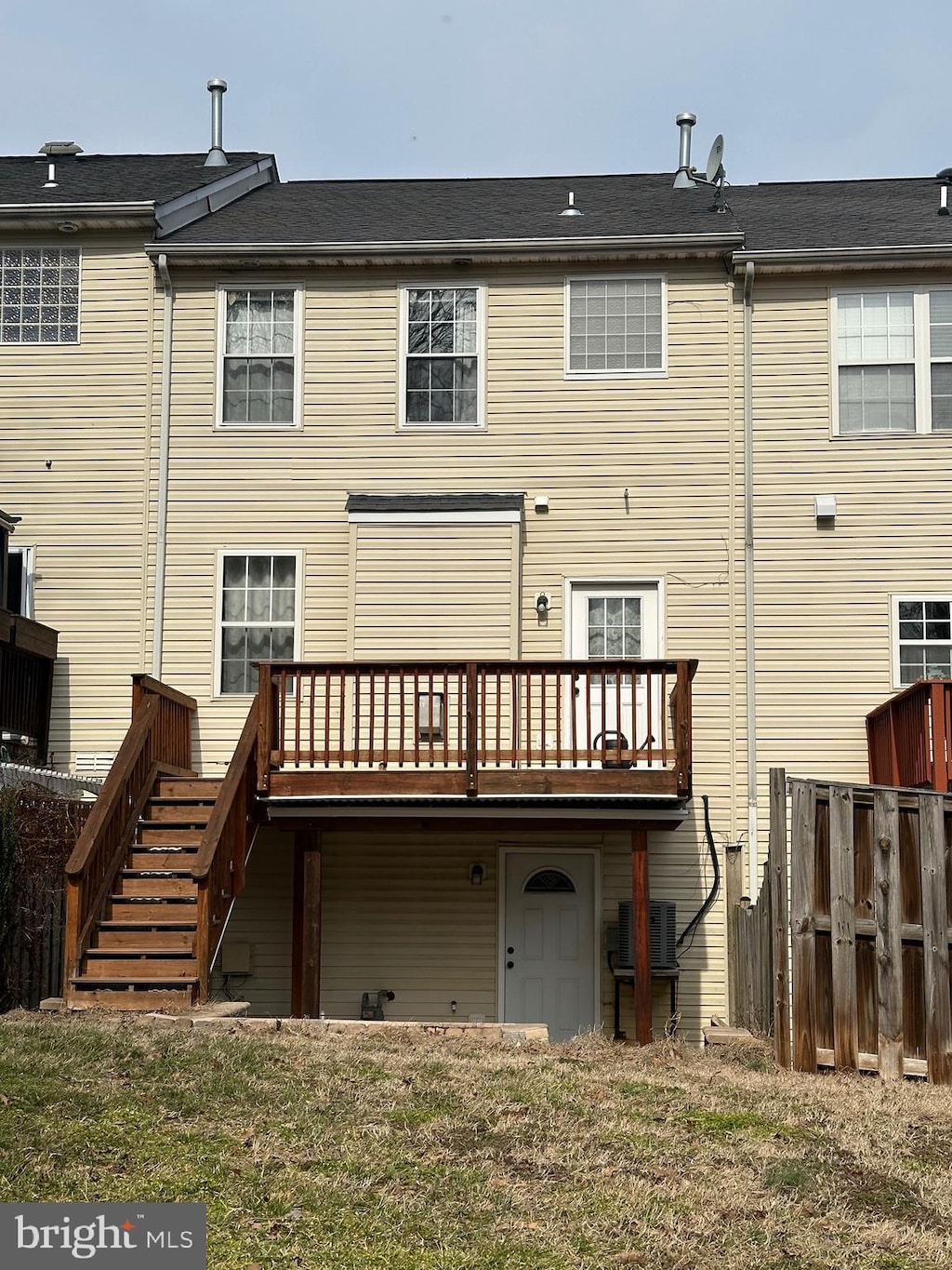 back of house with central AC unit, a deck, stairs, and fence