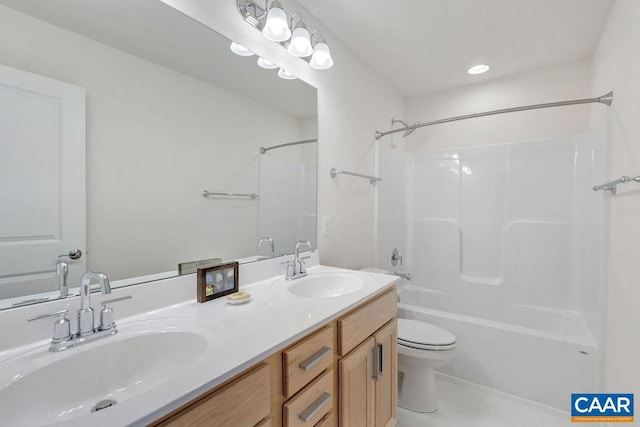 bathroom featuring double vanity, shower / tub combination, a sink, and toilet