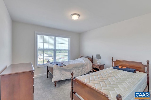 carpeted bedroom featuring baseboards