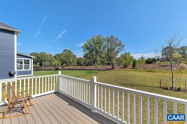 wooden deck featuring a yard