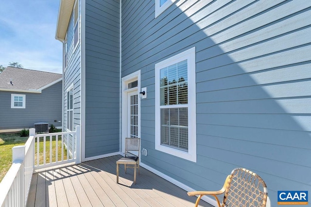 wooden deck featuring central AC unit