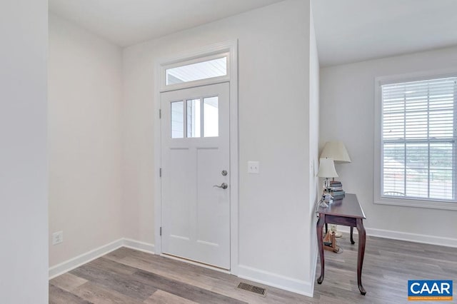 foyer with visible vents, baseboards, and wood finished floors