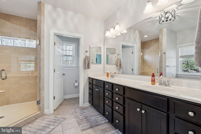 bathroom featuring a stall shower, plenty of natural light, and a sink