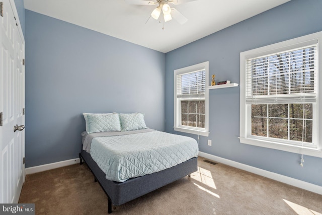 bedroom featuring baseboards, visible vents, and carpet flooring