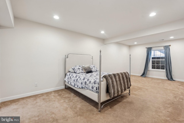 bedroom with baseboards, recessed lighting, and light colored carpet