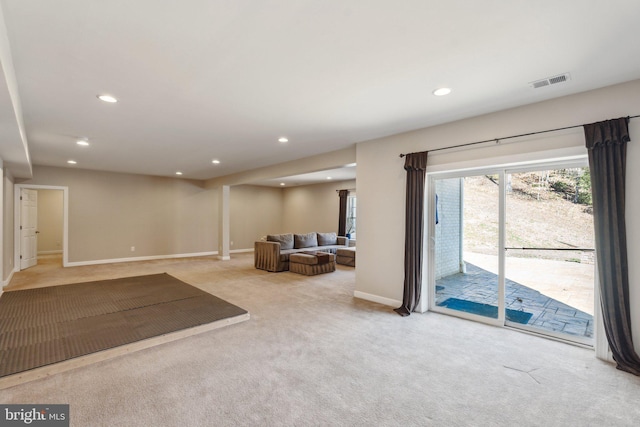 unfurnished living room featuring carpet floors, recessed lighting, visible vents, and baseboards