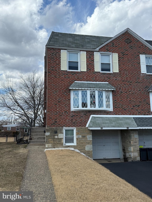 view of front of home with brick siding, driveway, and an attached garage