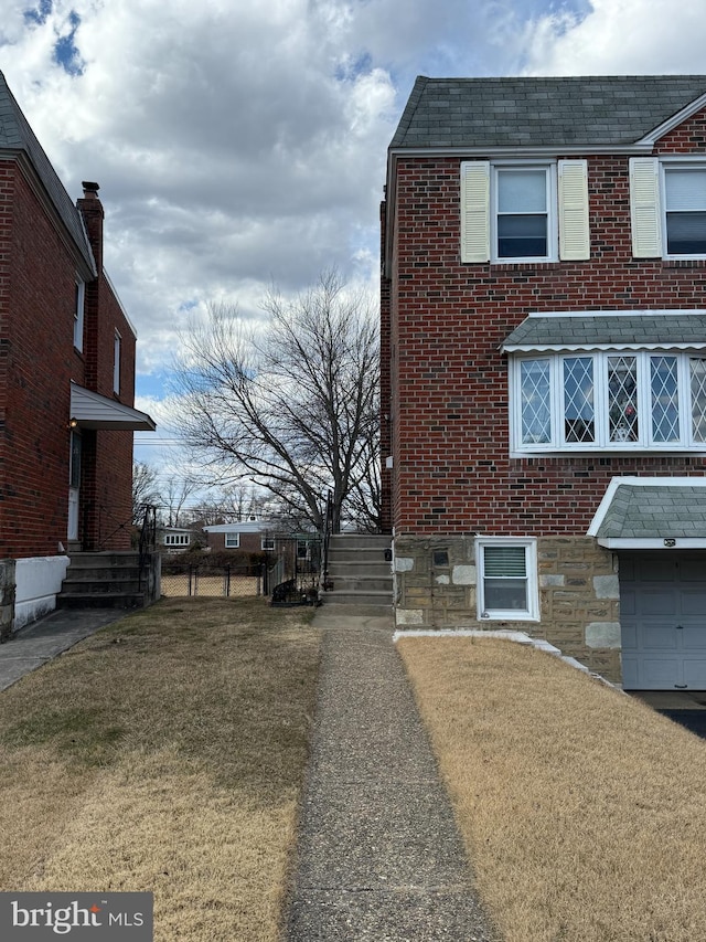 view of side of property with a yard and brick siding