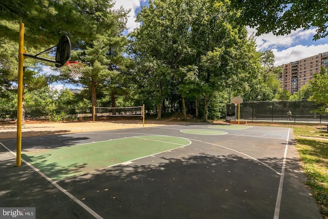 view of basketball court with community basketball court, fence, and volleyball court