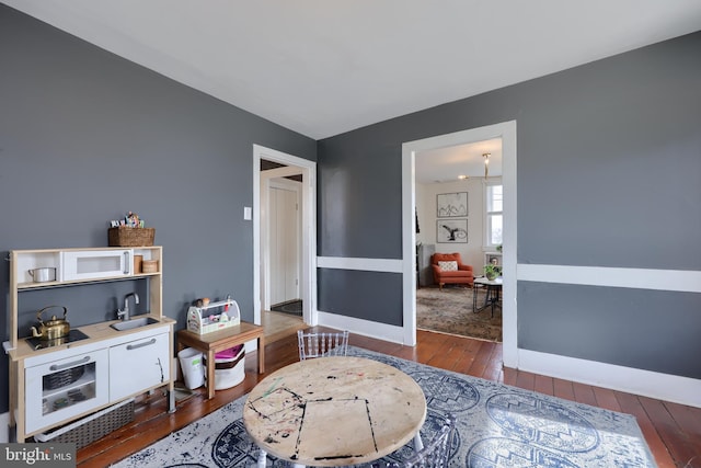 interior space with wood-type flooring and baseboards