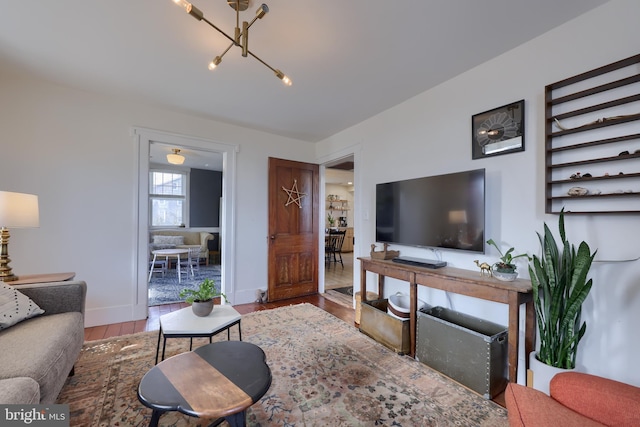 living area with baseboards and wood finished floors